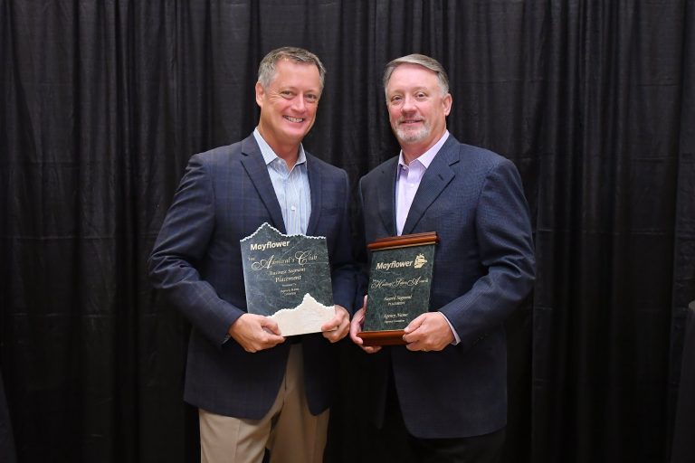 Rick and Chip Dircks posing with awards.